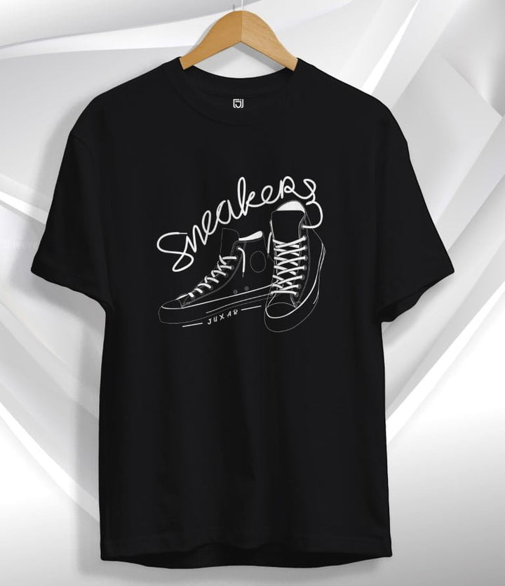 Juxar black sneaker graphic t-shirt featuring white outlined sneaker design and text on front