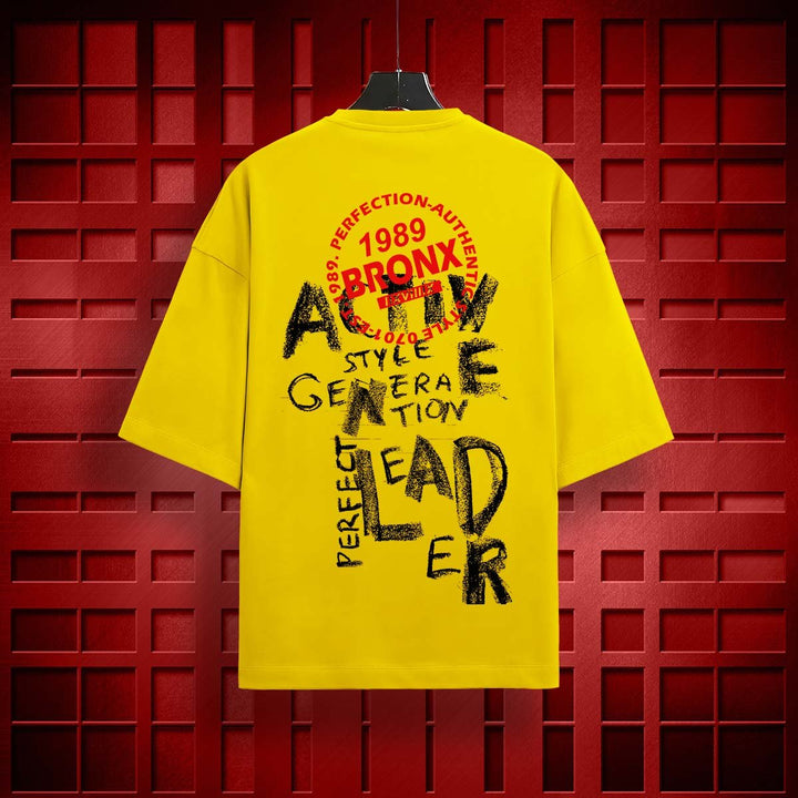 Juxar yellow oversized loose fit t-shirt with black and red Bronx graphic text on back