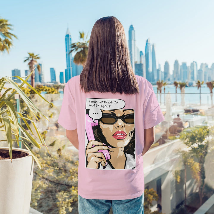 Juxar pink baggy boyfriend t shirt featuring comic pop art woman on back holding phone with city skyline