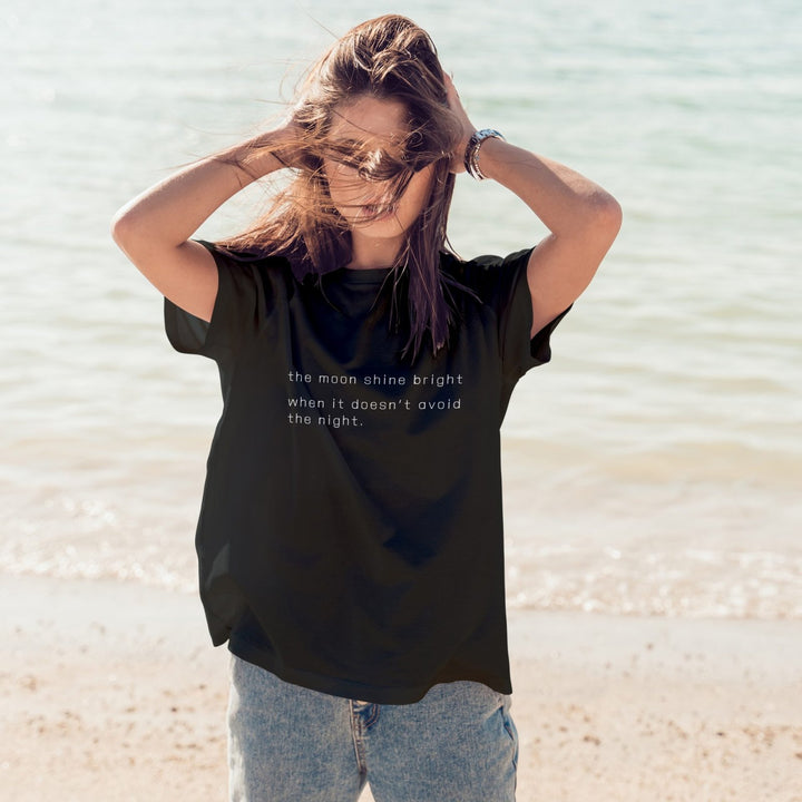 Juxar relaxed boyfriend t shirt for summer black oversized tee with printed quote worn on beach