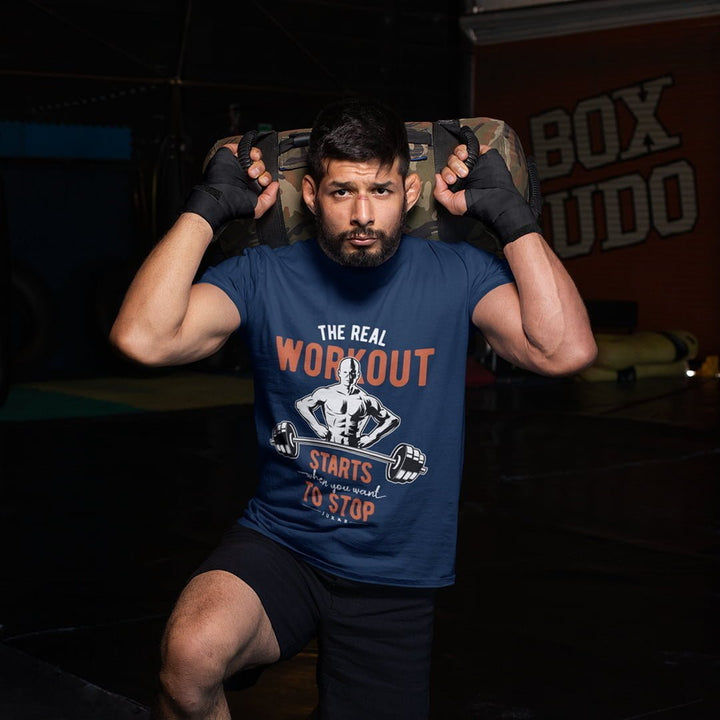 Juxar navy blue cotton t shirt for gym with workout graphic worn by man lifting weight bag