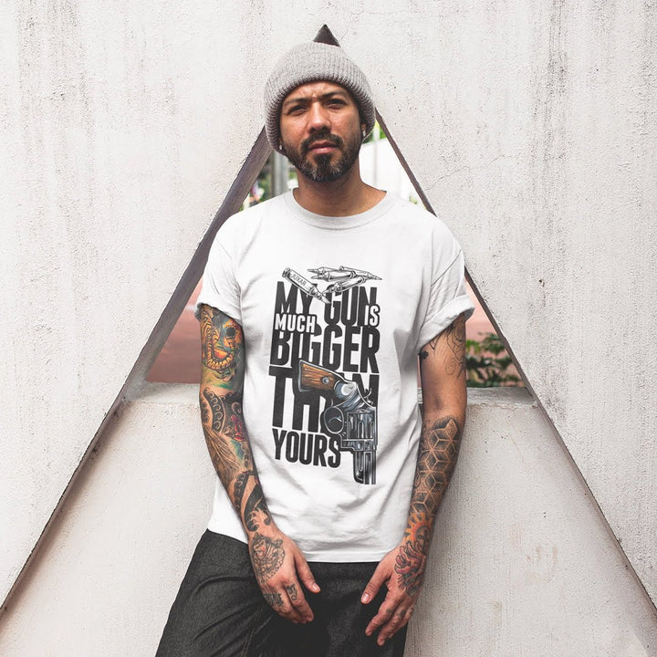 Juxar cotton t shirt multi-color with bold graphic text and gun illustration worn by tattooed man