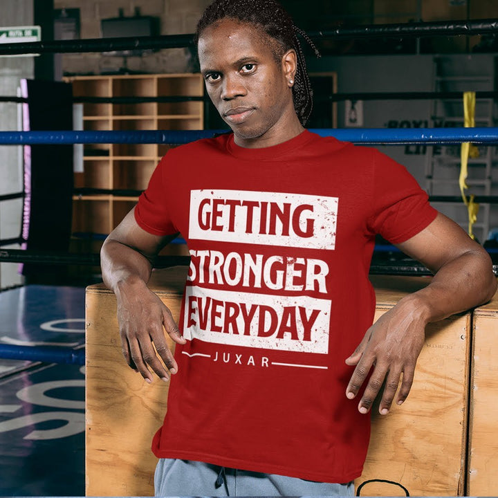 Juxar custom print cotton t shirt in red with Getting Stronger Everyday text worn by man in gym