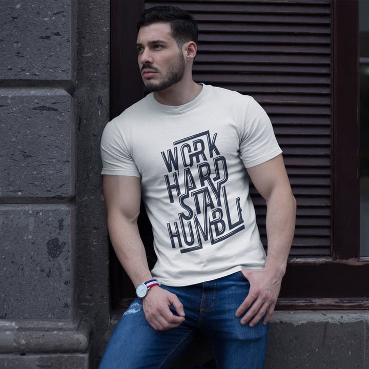 Juxar durable cotton t shirt with Work Hard Stay Humble print worn by man leaning against wall