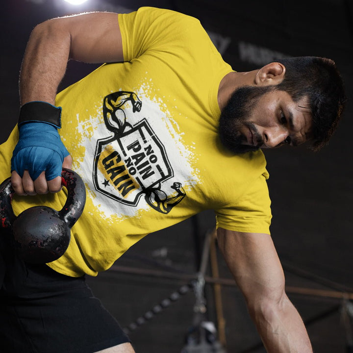 Juxar fitness slogan t-shirt for men in yellow with No Pain No Gain design worn during kettlebell workout