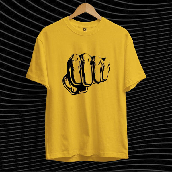Juxar yellow graphic punch t-shirt with black fist illustration on front hanging on wooden hanger