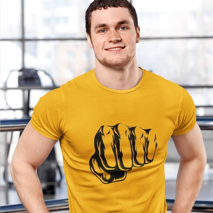 Juxar graphic punch t-shirt in yellow with bold black fist design worn by smiling man