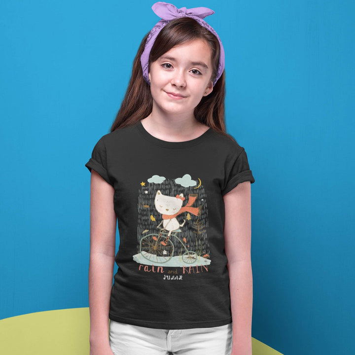 Juxar girls T shirt with cat on bike under clouds and stars playful graphic rainy day cartoon t-shirt
