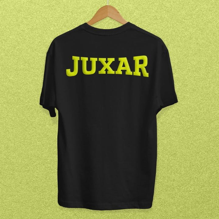 Black affordable cotton t shirts by Juxar with bold yellow logo on back hanging on wooden hanger
