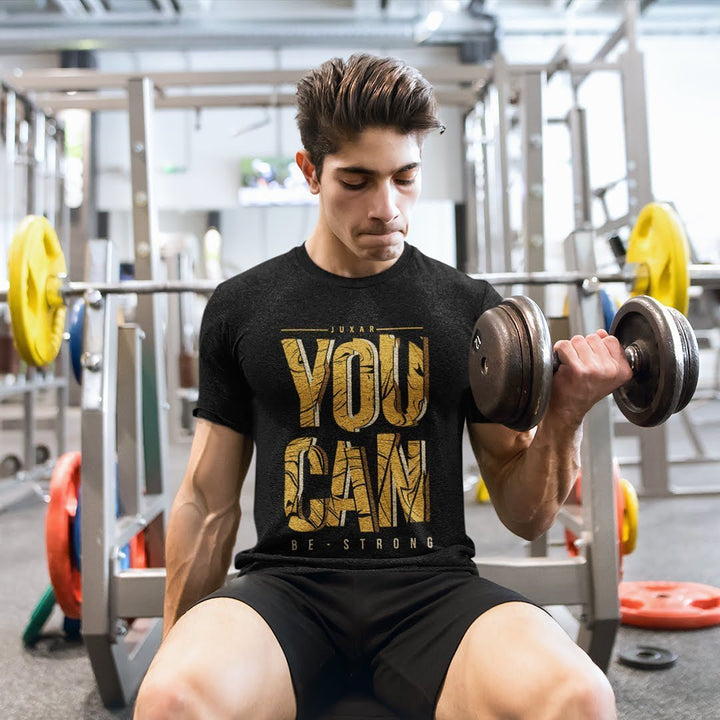 Juxar cotton t shirt for teenagers in black with You Can print worn by a teen lifting dumbbells