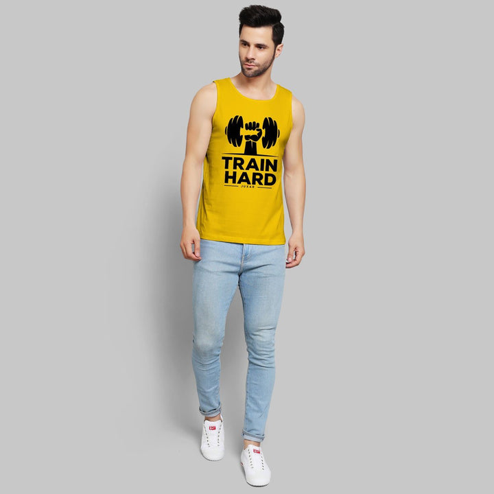 Juxar mens yellow fashion gym sando with train hard print paired with light blue jeans and white sneakers