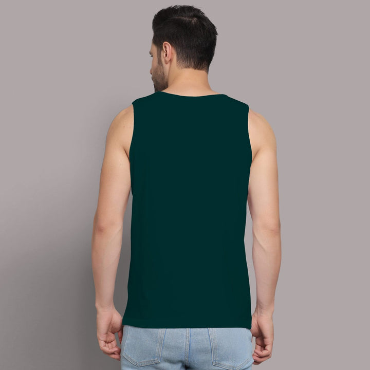 Back view of man wearing dark green Juxar fitness sando for men with sleeveless design and light blue jeans