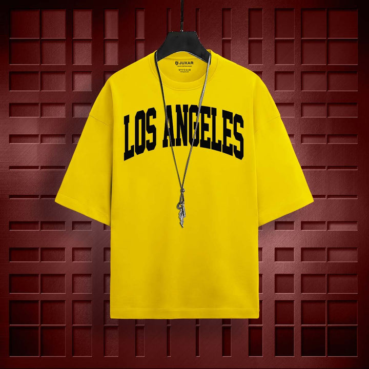 Juxar yellow lost reality oversized t-shirt with Los Angeles print hanging on black hanger