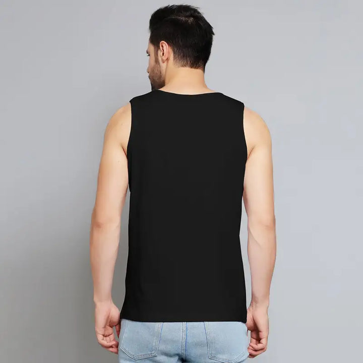 Back view of a man wearing a black my evil side muscle tee by Juxar paired with light blue jeans