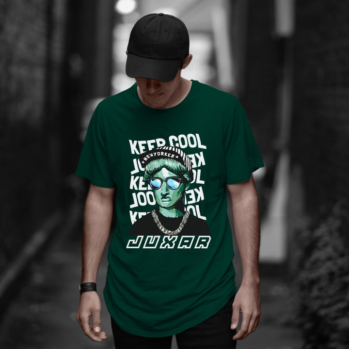 Juxar green cotton longline tee with bold graphic worn by male model in cap not a plain longline t shirt