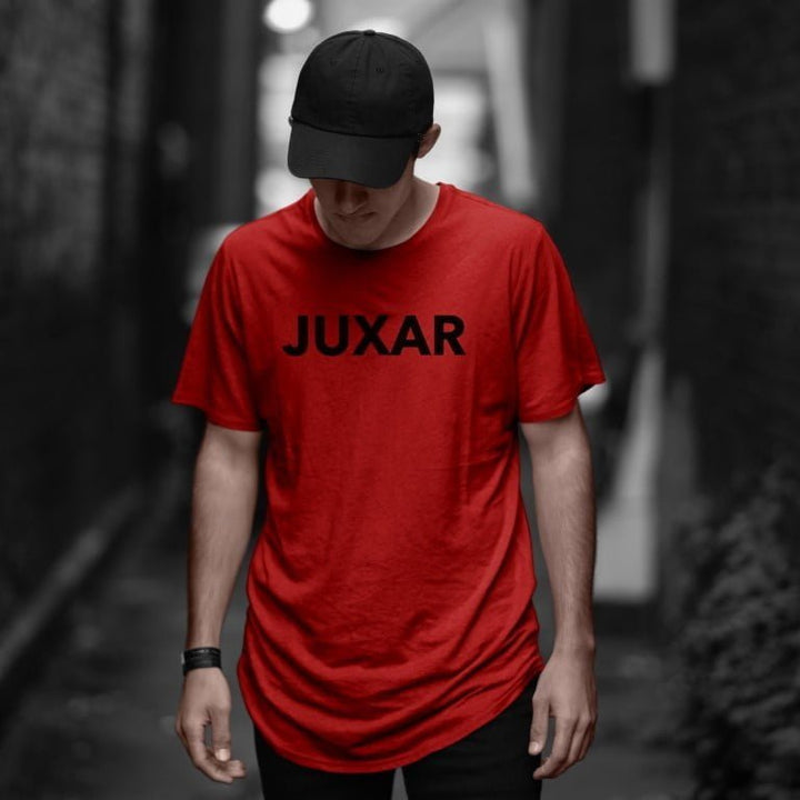Male model wearing Juxar red premium cotton longline t shirt with black cap in urban alley