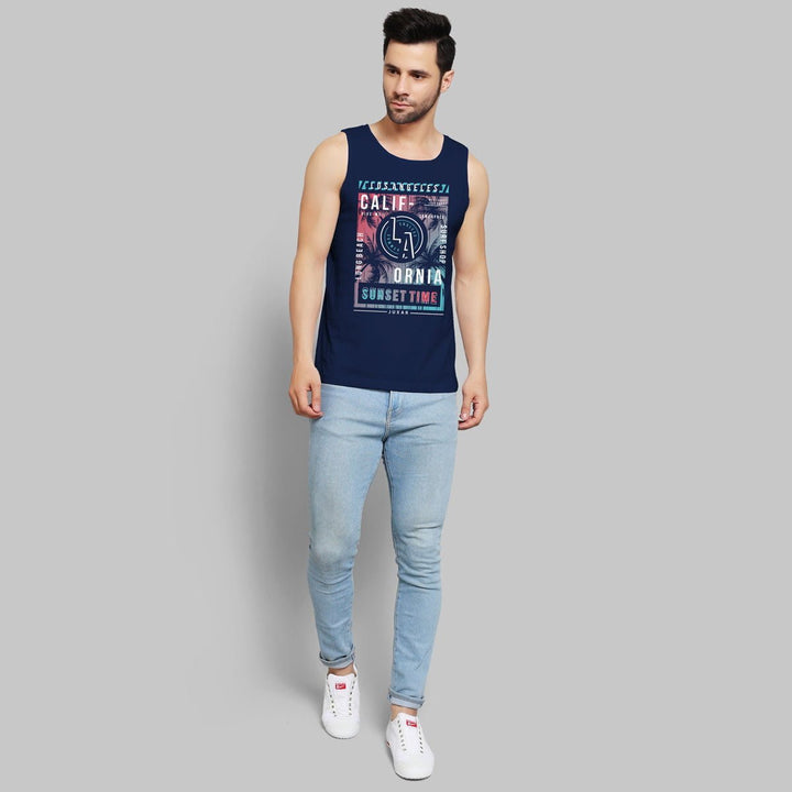 Juxar mens navy sunset graphic tank top with California print paired with light blue jeans and white sneakers