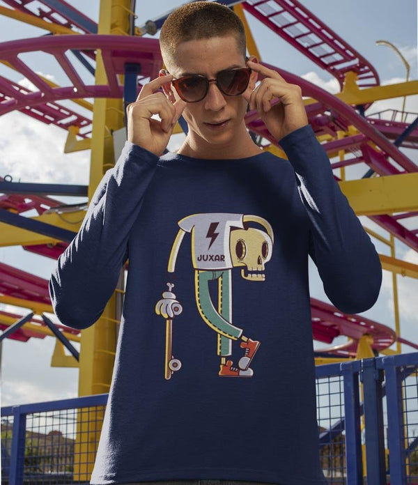 Juxar navy tee worn by model with trendy graphic long sleeve t shirt showing cartoon skull skateboard design at park