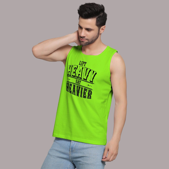 Juxar bright green vest mens sandos with Lift Heavy Eat Heavier text worn by man posing