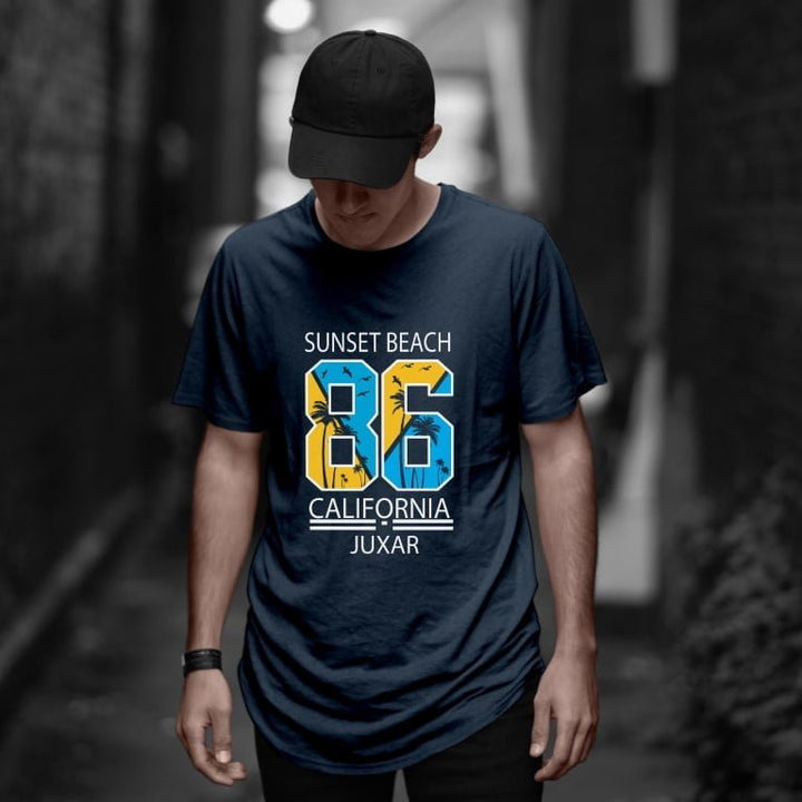 Juxar navy vintage cotton longline t shirt with Sunset Beach 86 California graphic worn by male model in alley