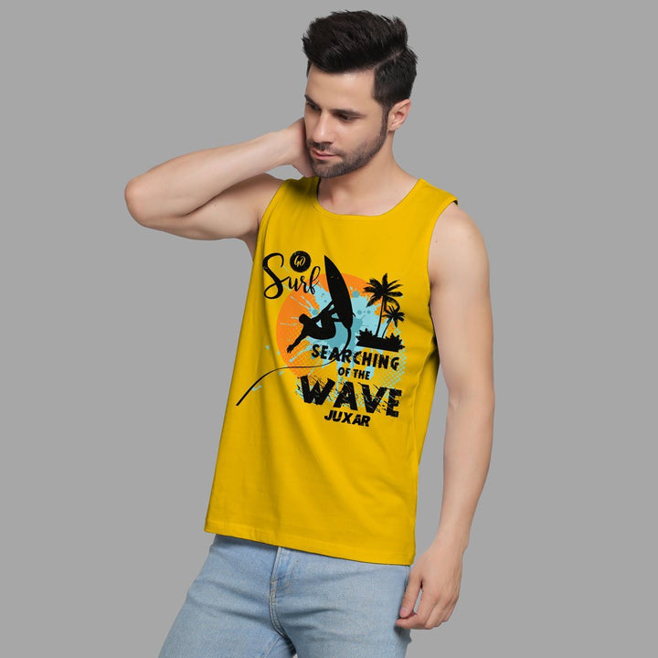 Juxar yellow surf sando for beachwear with surfing graphic worn by man in light blue jeans