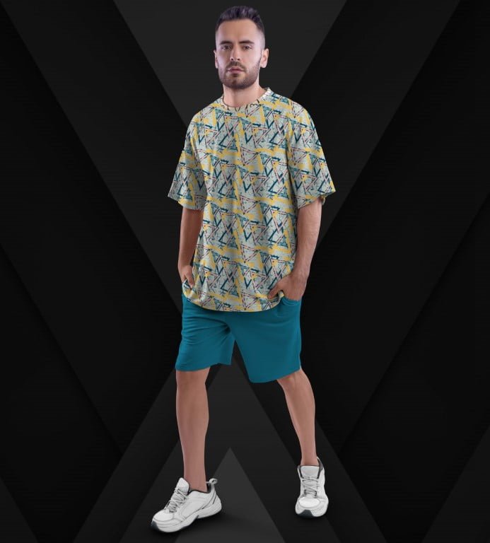 Juxar aesthetic oversized printed t shirt on male model with geometric yellow blue print and teal shorts