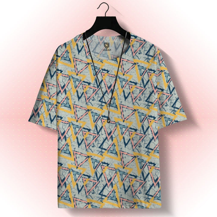 Juxar aesthetic oversized printed t shirt with pastel geometric triangle print hanging on a black hanger