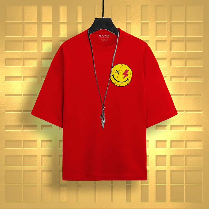 Juxar red oversized t-shirt with smiley face graphic and necklace on hanger against gold background