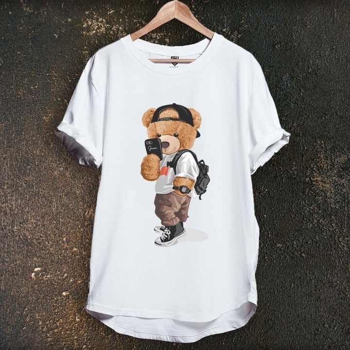 Juxar white longline tee with teddy bear wearing cap backpack and sneakers graphic on hanger casual cotton longline tee