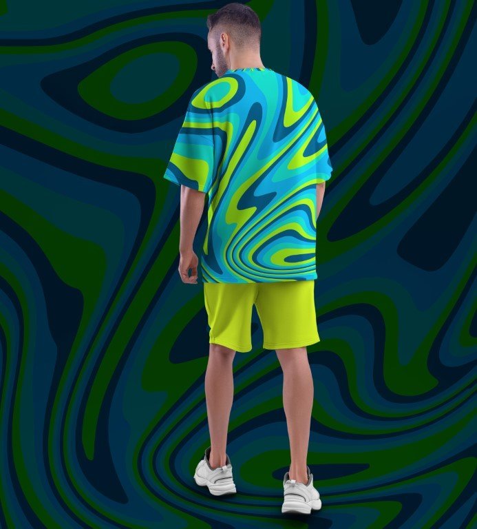 Juxar wearing cool printed oversized t shirt streetwear blue green swirl print with neon yellow shorts and white sneakers