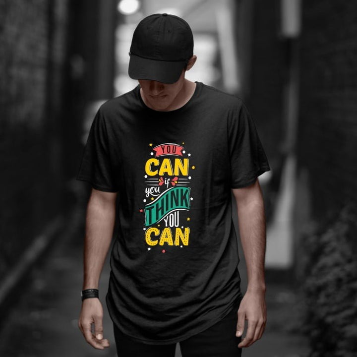 Juxar casual oversized longline cotton t shirt black with colorful You Can motivational print worn by male model in alley