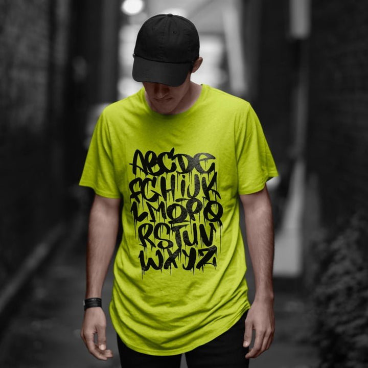 Juxar plain cotton longline t shirt neon green with black graffiti alphabet print modeled by man in cap