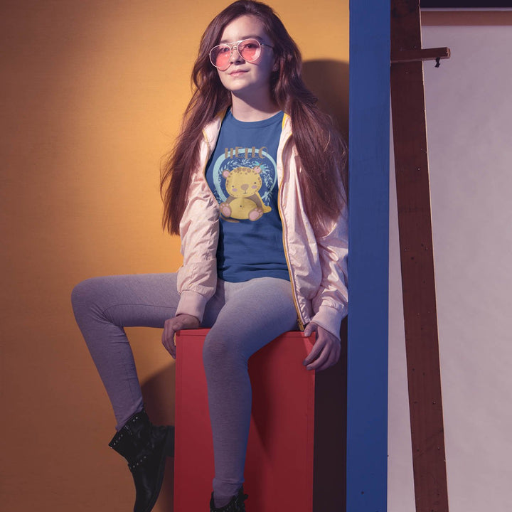 Juxar sporty t shirt for girls modeled by teen in blue graphic tee with pink jacket gray leggings and boots
