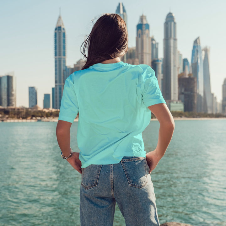 Juxar loose fit boyfriend style t shirt seafoam back view on woman by waterfront skyline for casual relaxed wear