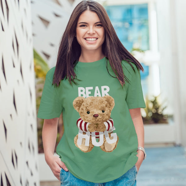 Juxar green summer boyfriend t shirt with teddy bear hug graphic worn by smiling woman in casual setting