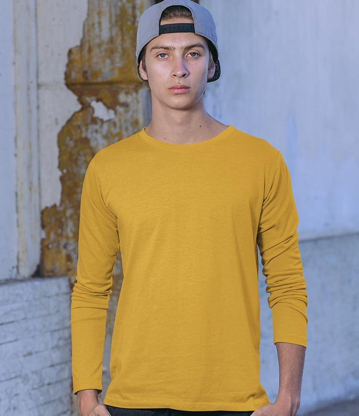 Juxar mustard long sleeve tee worn by male model with cap in urban setting everyday wear cotton long sleeve t shirt