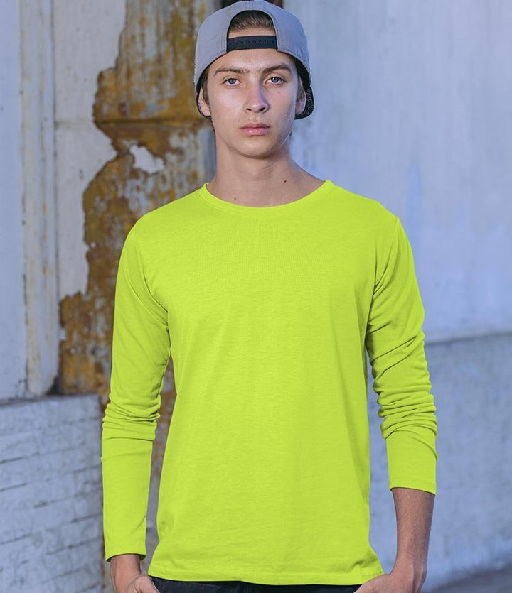 Juxar neon lime long sleeve crewneck on male model with backwards cap in urban setting everyday wear cotton long sleeve t shirt