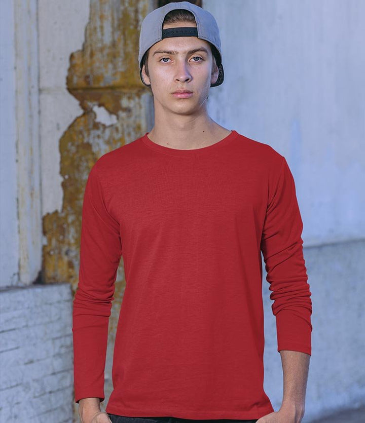 Juxar red long sleeve t shirt worn by male model with cap in urban setting everyday wear cotton long sleeve t shirt