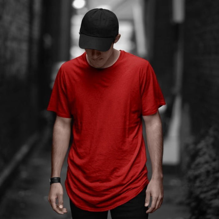 Juxar red cotton longline tee on male model with black cap in alley soft cotton longline tee for everyday wear