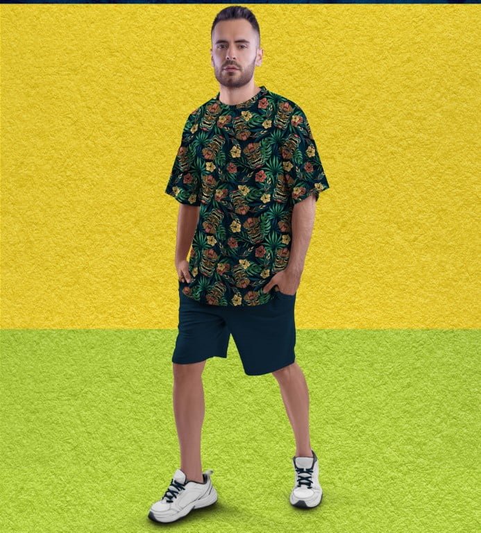 Juxar trendy full printed oversized t shirt with tropical floral pattern worn by male model with shorts and sneakers
