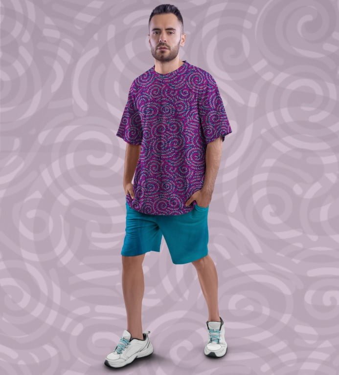 Juxar model wearing purple printed over print oversized t shirt unisex with teal shorts and sneakers