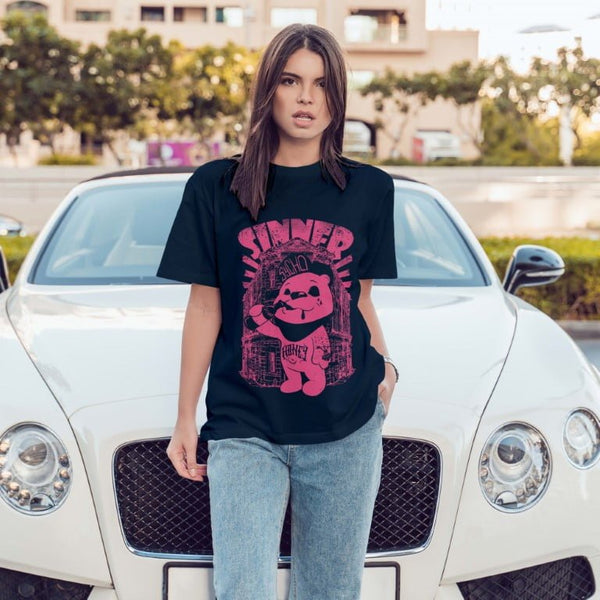 Juxar oversized boyfriend t shirt for women black graphic tee with pink cartoon print worn by model in front of white car