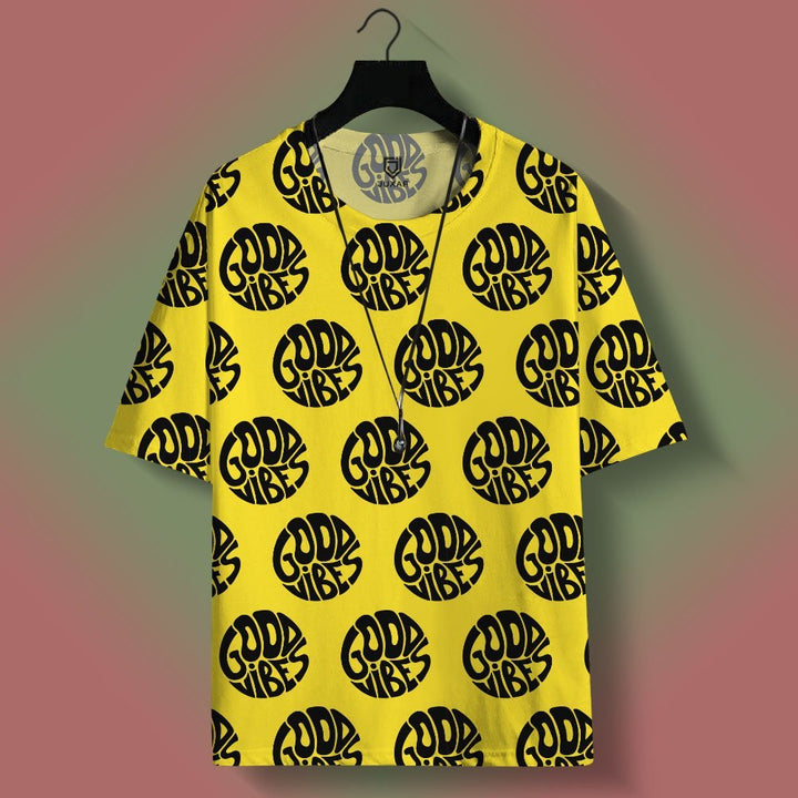 Juxar street style oversized printed t shirt in yellow with repeating black Good Vibes logo pattern