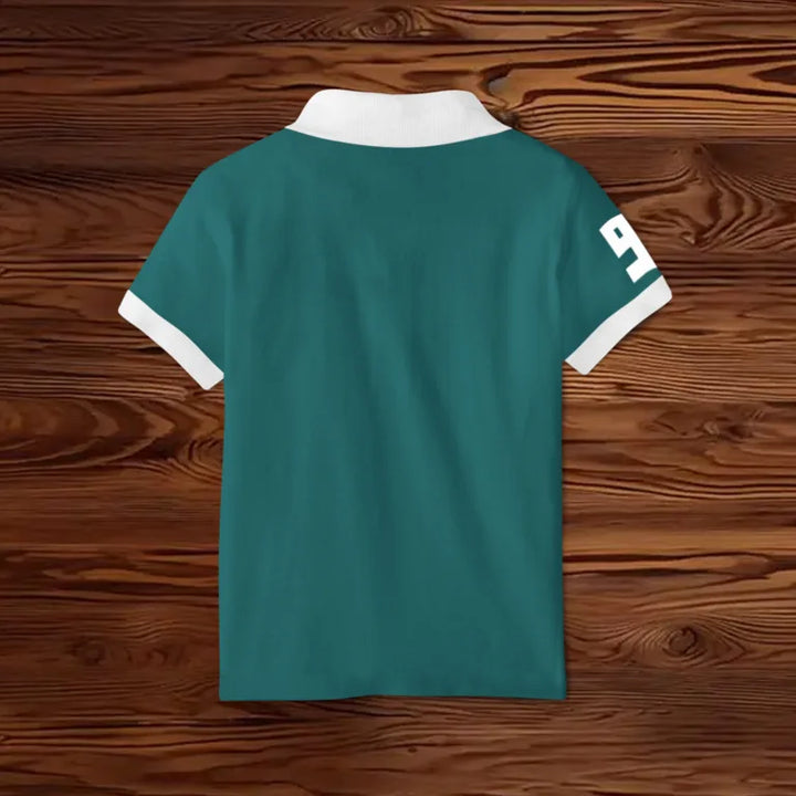 Juxar trendy cotton polo tee back view in teal with white collar and cuffs and sleeve number 9 on wooden background